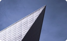 Striking angular architecture of the Denver Art Museum rises sharply against a clear blue sky—showcasing modern design and artistic innovation in the heart of downtown Denver.
